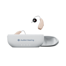 Load image into Gallery viewer, Audien Ion Pro hearing aids with one in charging case and one suspended above, front view